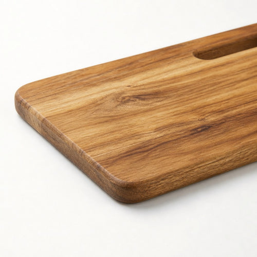 Acacia serving board corner close-up showing edge thickness and grain