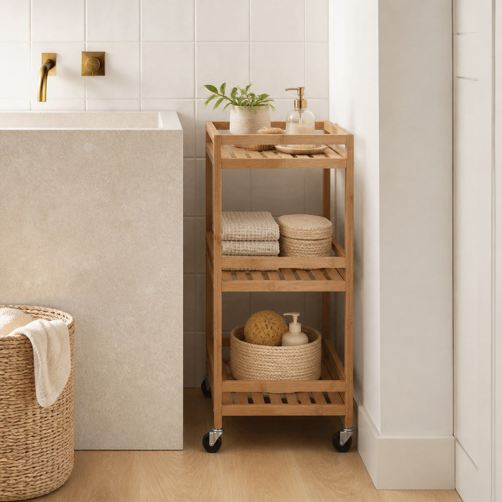 Slim bathroom cart tucked beside a stone basin