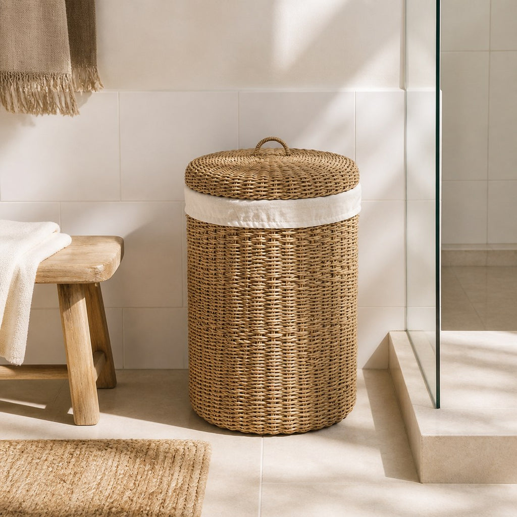 Woven laundry hamper in the corner of a bright bathroom