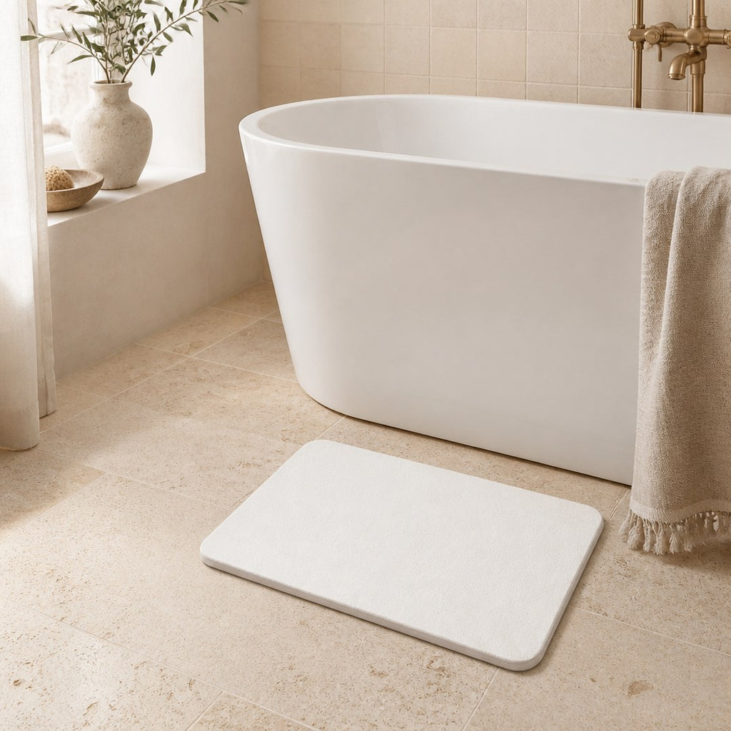 Diatomite bath mat at the foot of a freestanding tub