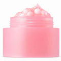 Open pink capsule cream jar with pink capsules