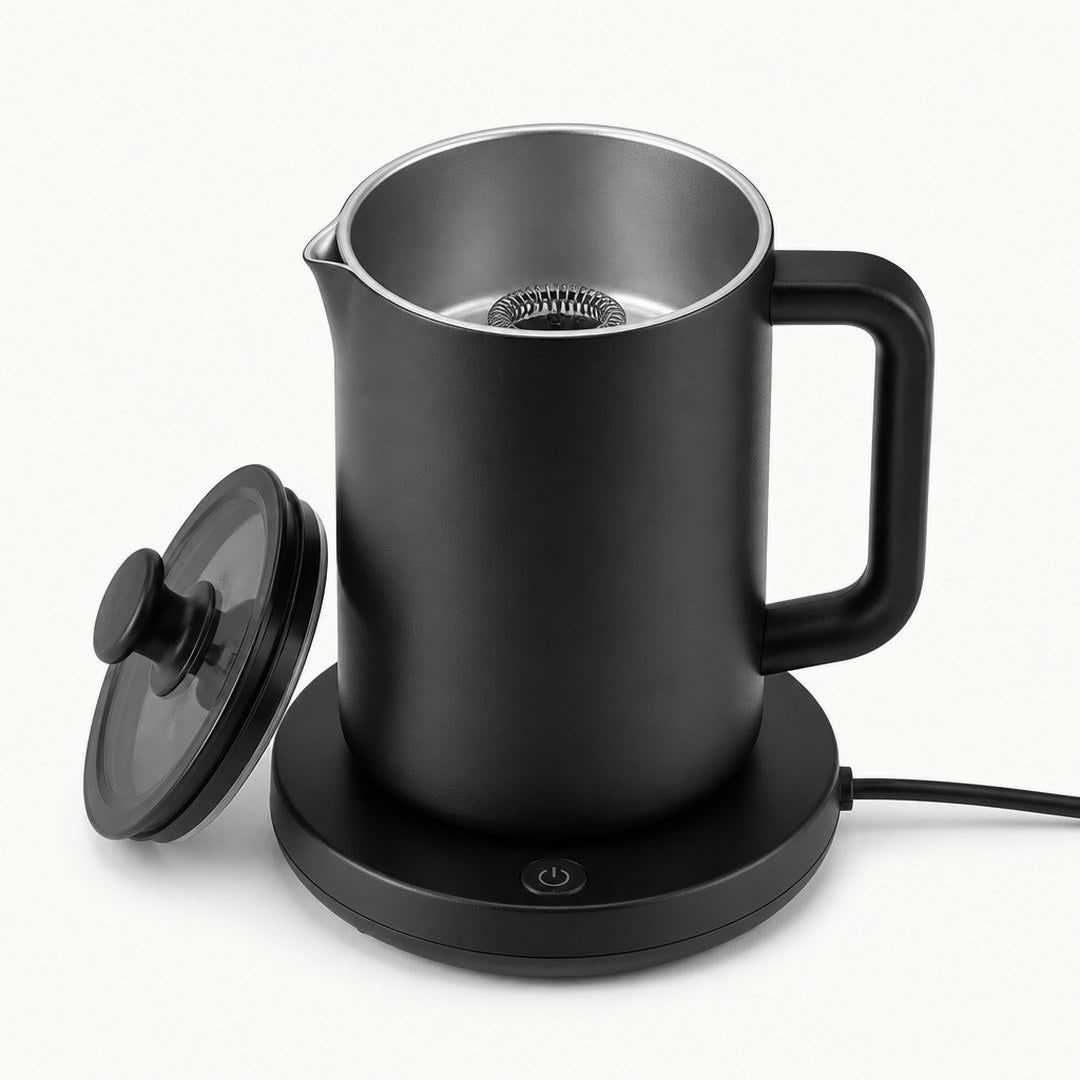 Electric milk frother with the lid off showing the whisk and inner jug