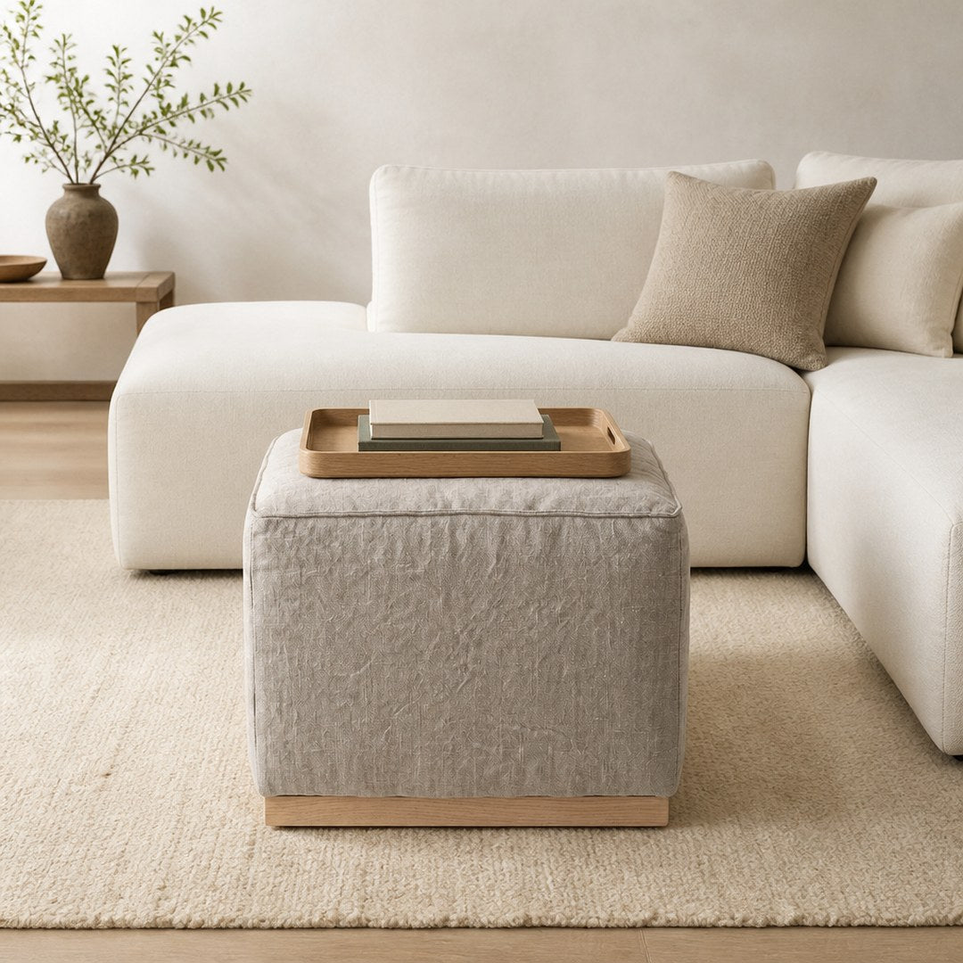 Linen Ottoman with a tray in front of a sofa