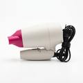 Glossy Compact Travel Hair Dryer folded with fuchsia nozzle