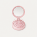 Folding brush with mirror