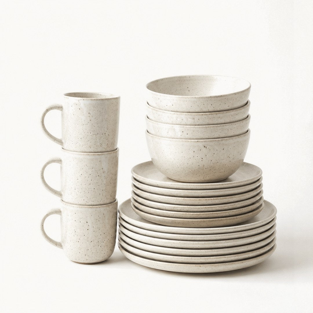 Stoneware dinner set stacked in columns of plates and bowls