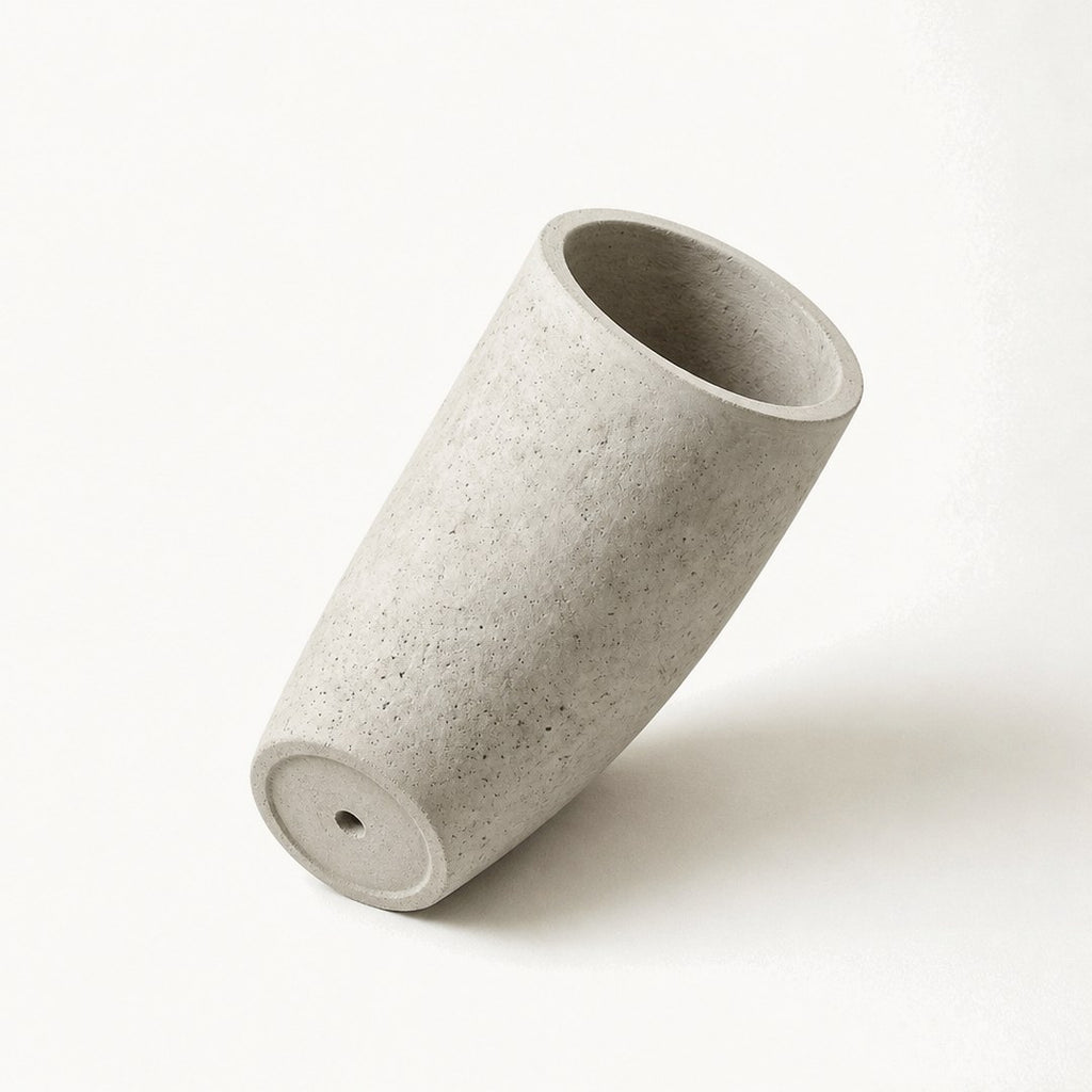 Tall concrete planter from below showing its tapered profile
