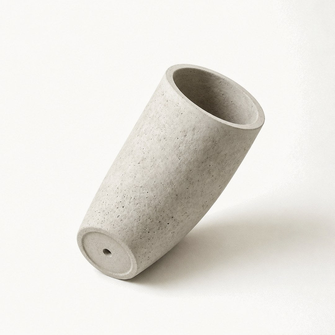 Tall concrete planter from below showing its tapered profile