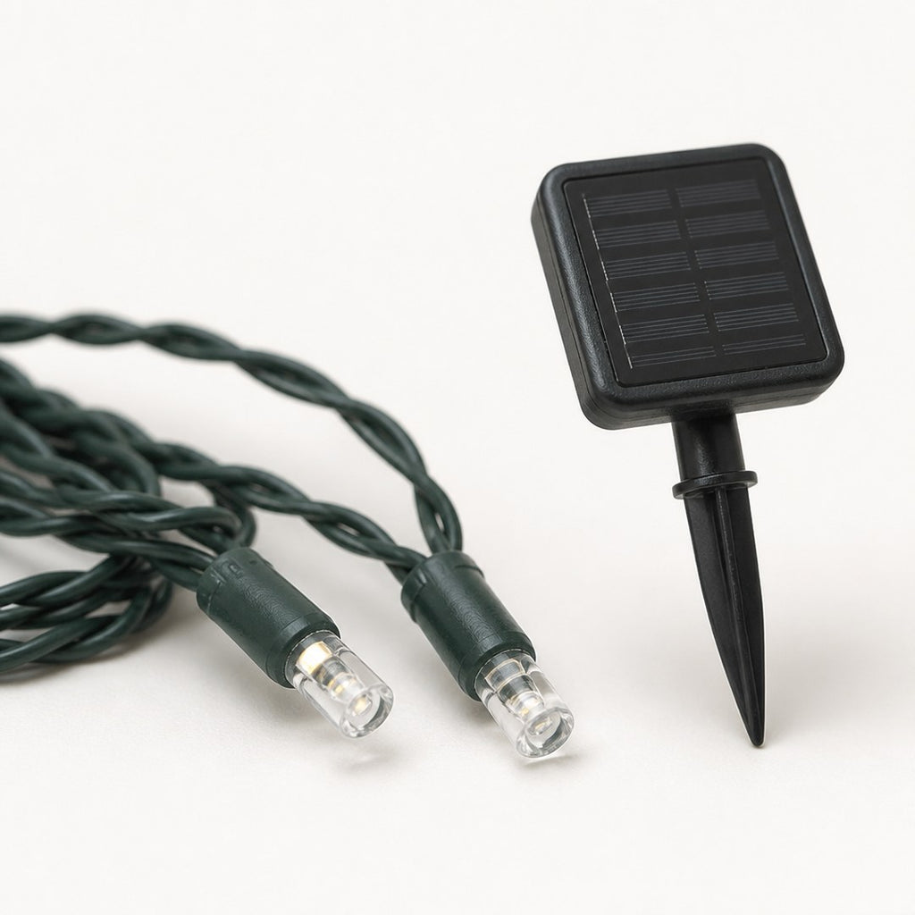 Close-up of two string light bulbs and the solar panel stake