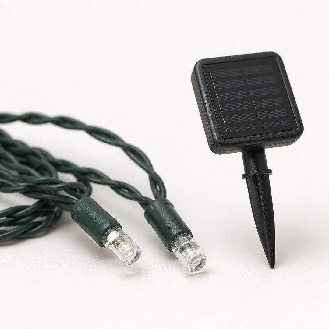 Close-up of two string light bulbs and the solar panel stake