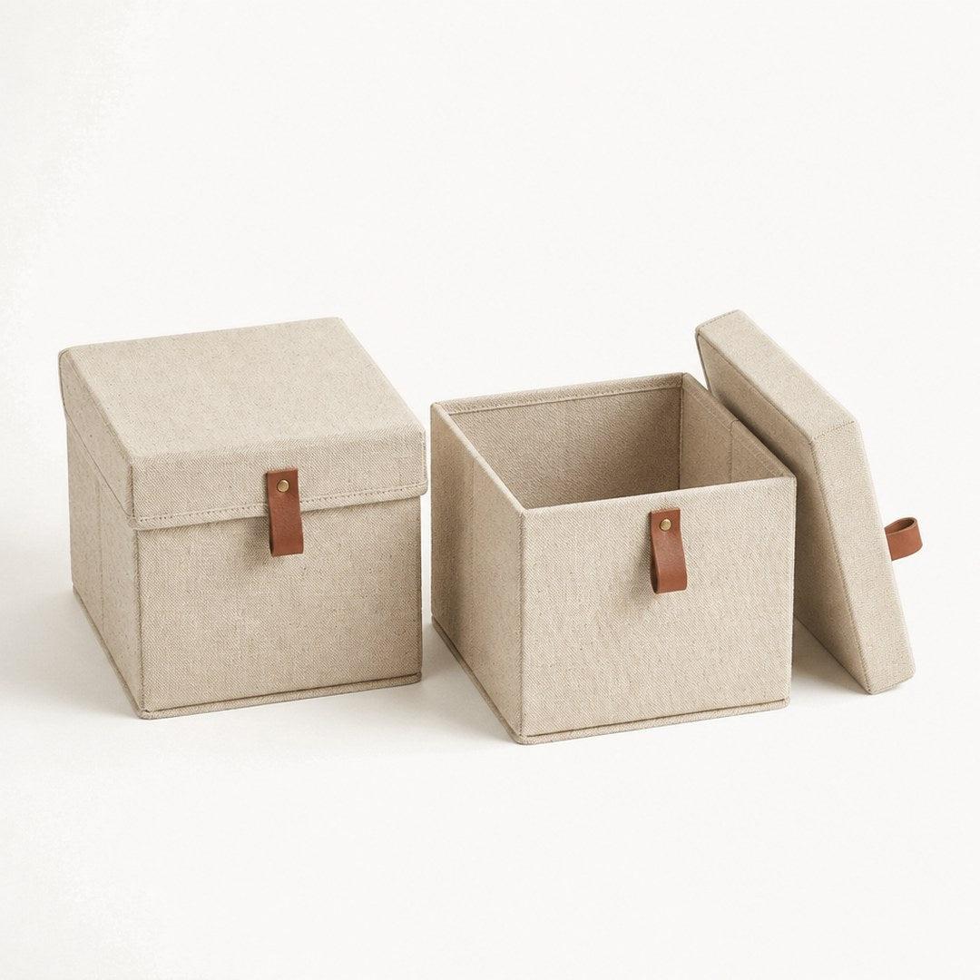 Two lidded fabric boxes with one lid removed revealing the interior