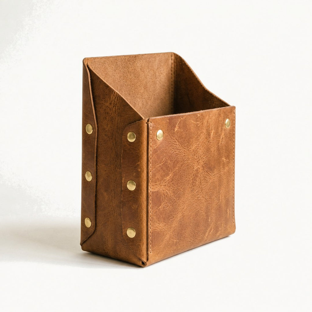 Leather magazine holder at an angle showing the side panel and open top