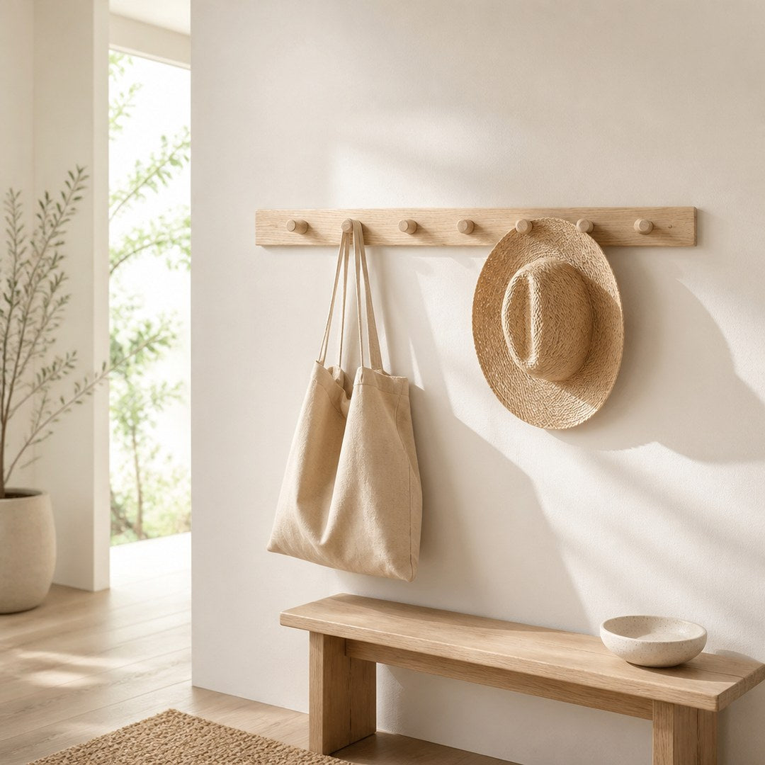 Peg rail mounted along a hallway wall with a bag and hat hanging