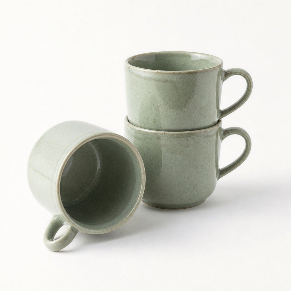Reactive glaze mugs stacked, showing the glazed interior