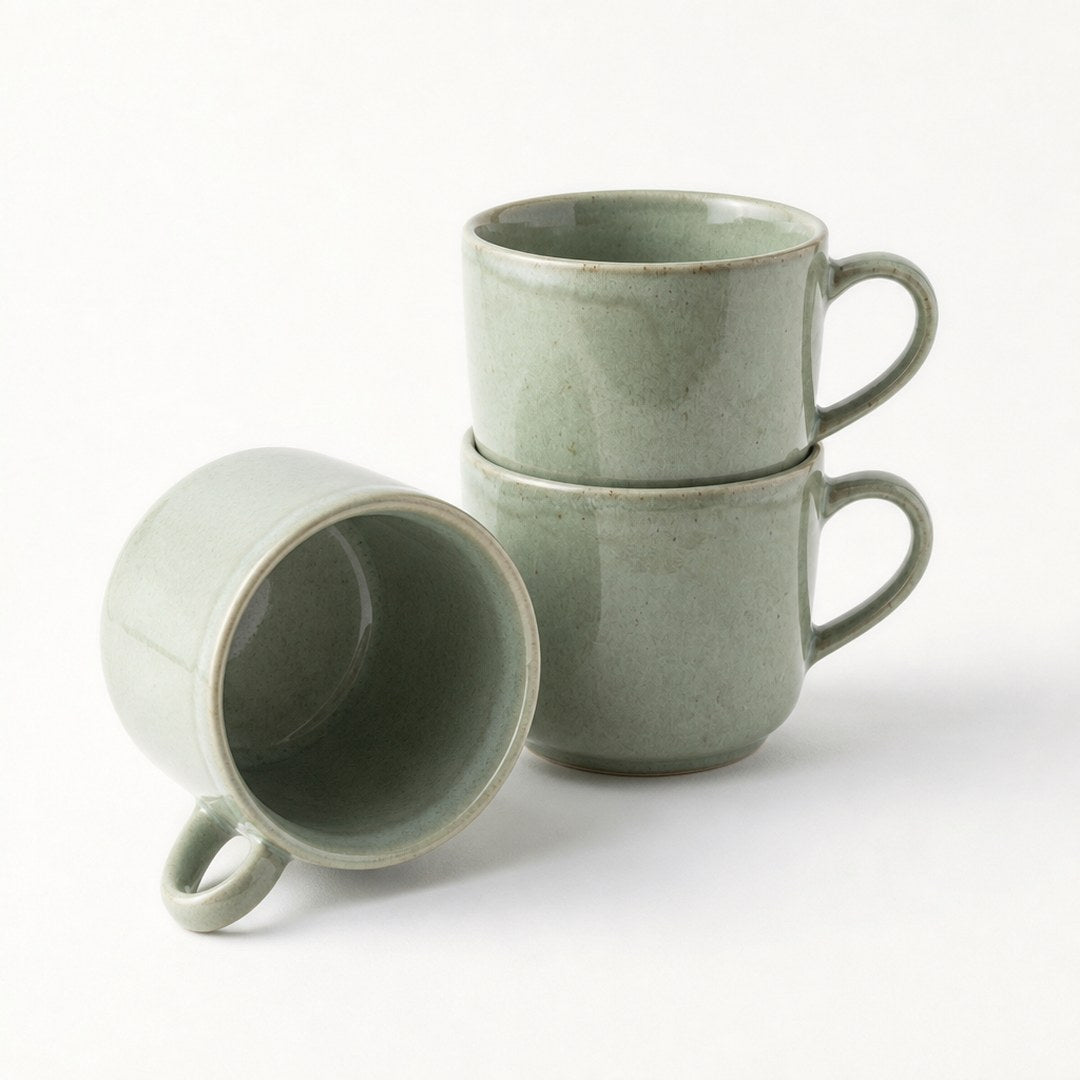 Reactive glaze mugs stacked, showing the glazed interior