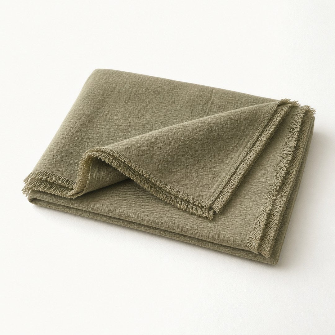 Linen bed scarf with one end folded back showing hem and layered thickness