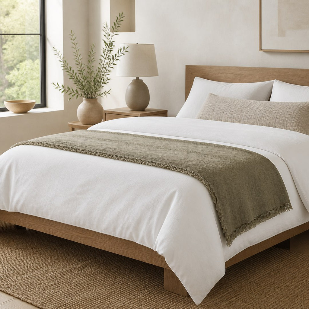Linen bed scarf laid across the foot of a made bed