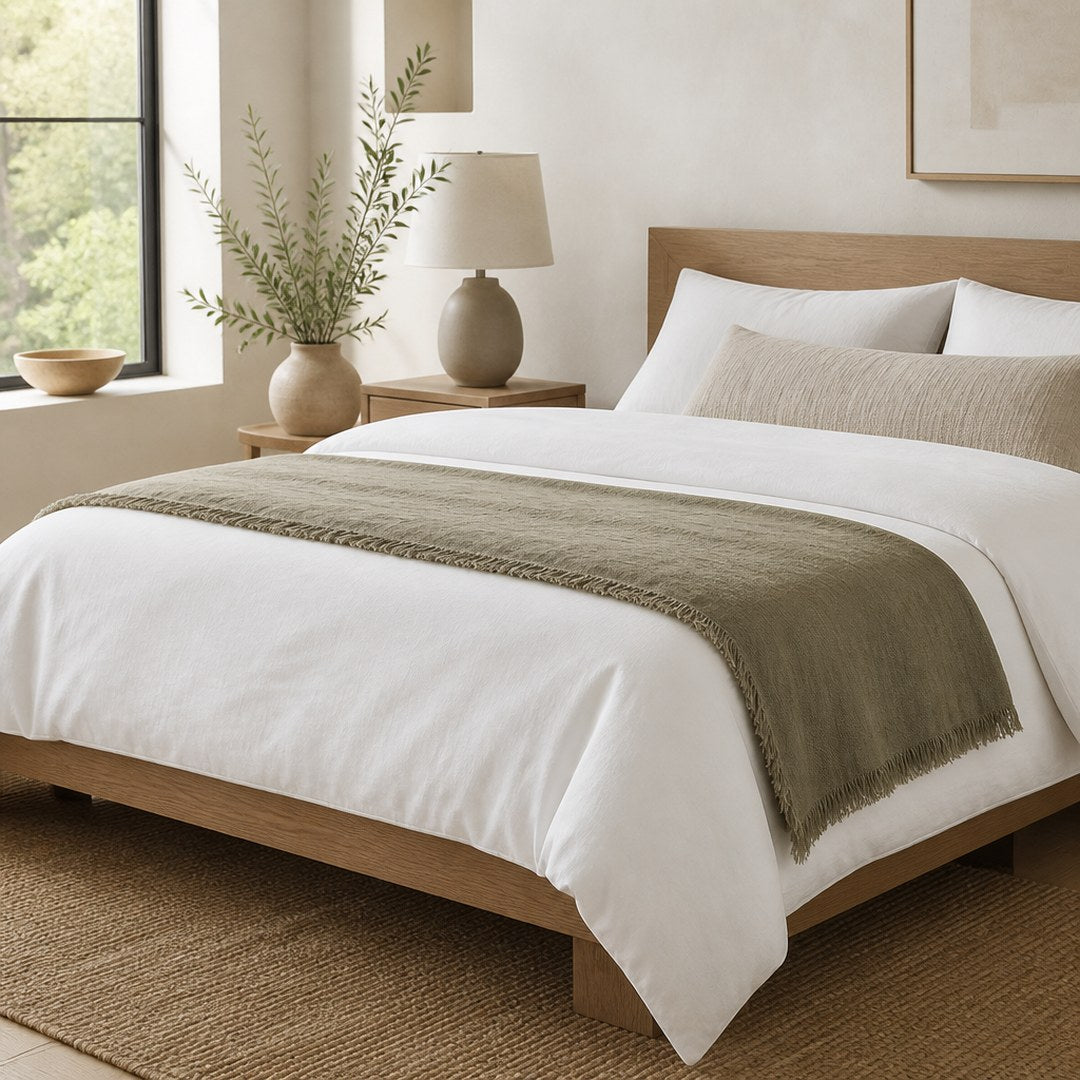 Linen bed scarf laid across the foot of a made bed