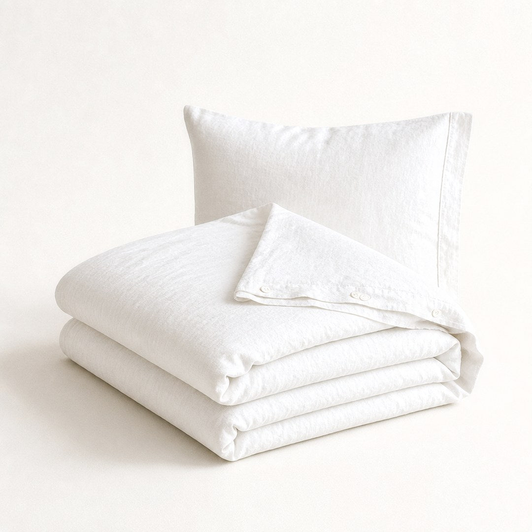 Linen duvet set with corner folded back and matching pillowcase behind