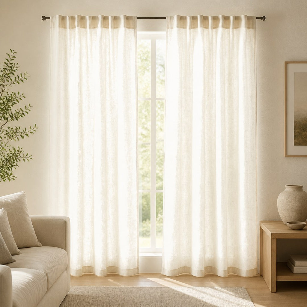 Sheer linen panels filtering daylight at a tall living room window