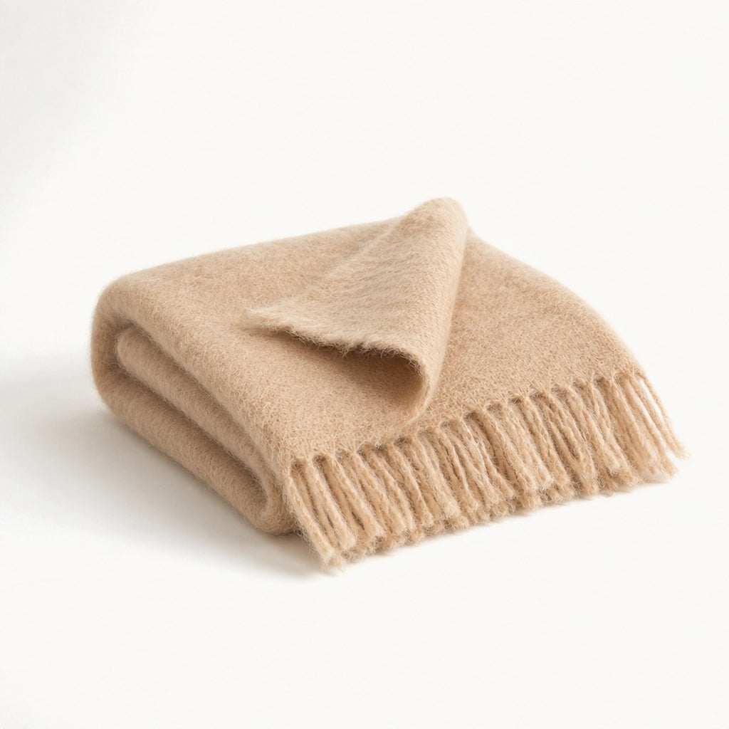 Mohair throw folded with corner turned back showing fringe and halo