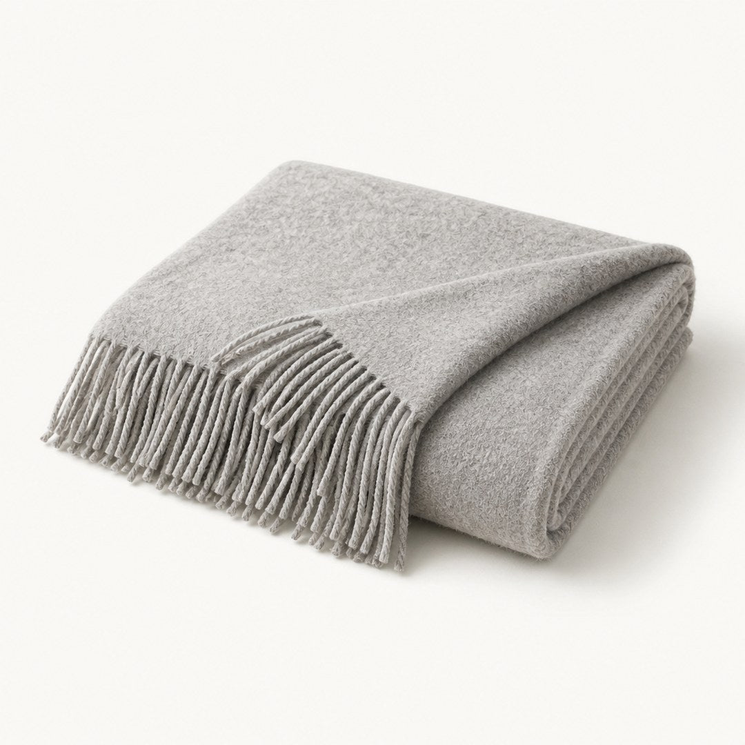 Lambswool throw folded with corner turned back showing fringed edge