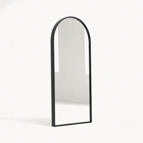Arched wall mirror seen from a three-quarter angle showing the frame depth