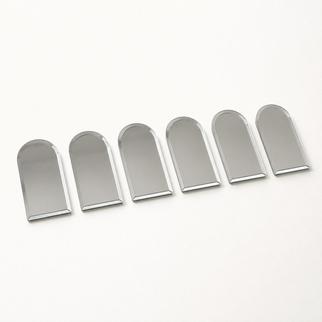 Six arch mirror tiles laid out separately showing individual thickness