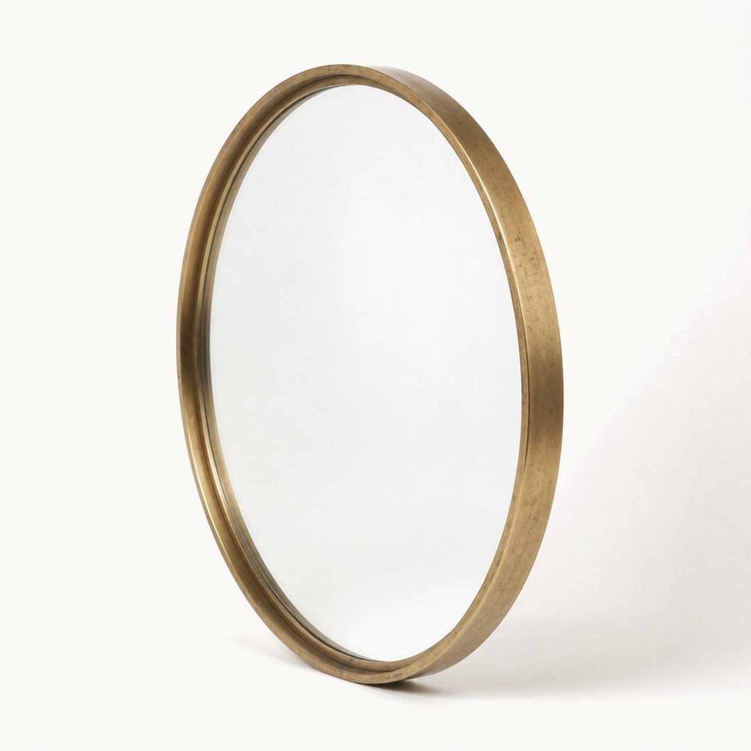 Round brass mirror at a three-quarter angle showing the slim rim profile